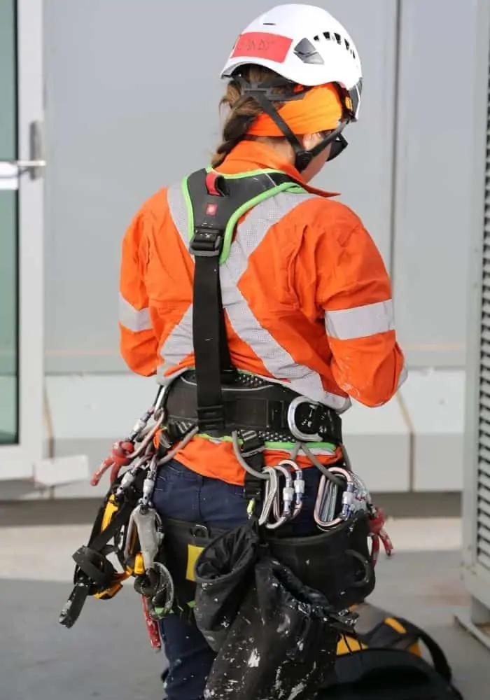 Rope access technician abseiling down a commercial building in Sydney